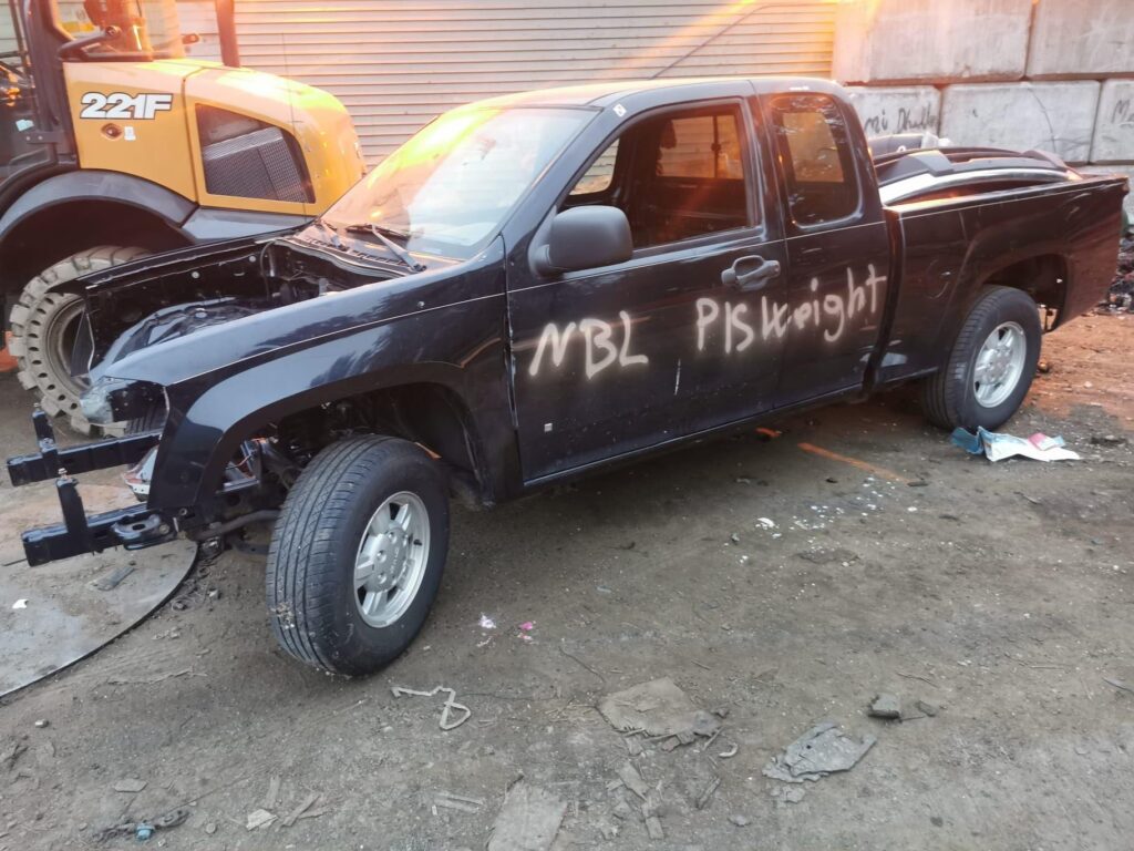 Cash for used cars pickup truck with front-end damage arriving at our Burnaby yard