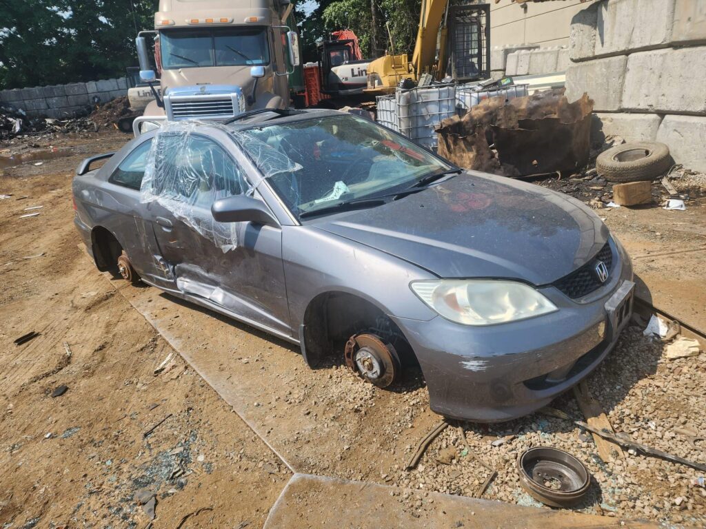 Local used car buyers picking up a Honda Civic missing its wheels in Burnaby