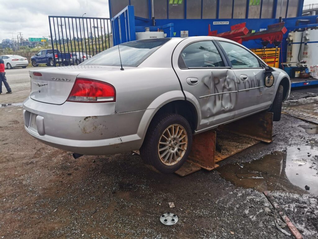Sell my car for cash example featuring a wrecked Chrysler Sebring sedan